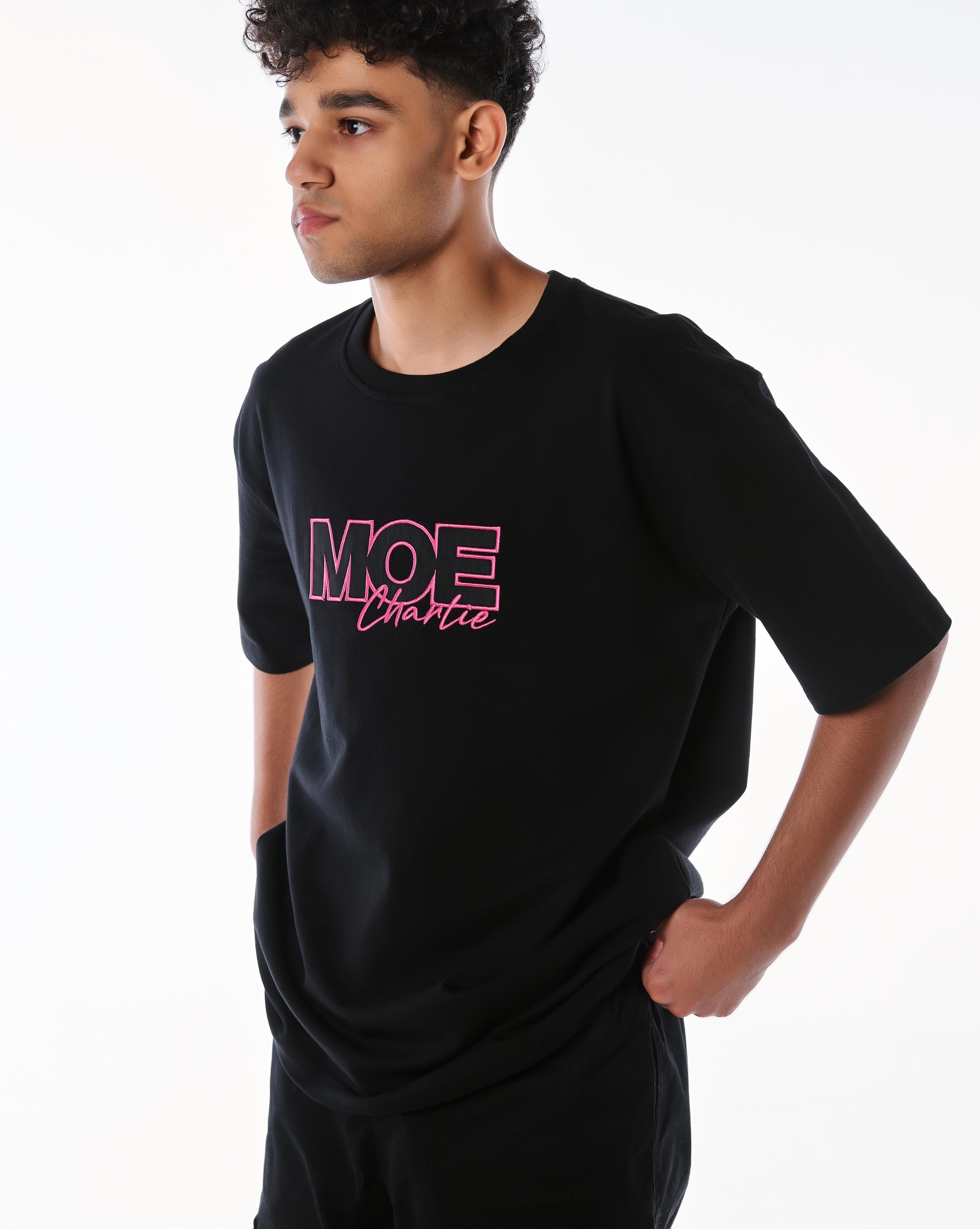 Nahaufnahme MOE CHARLIE Pink Passion T-Shirt Frontprint, pinke 3D-Stickerei Detail, Hand in Tasche