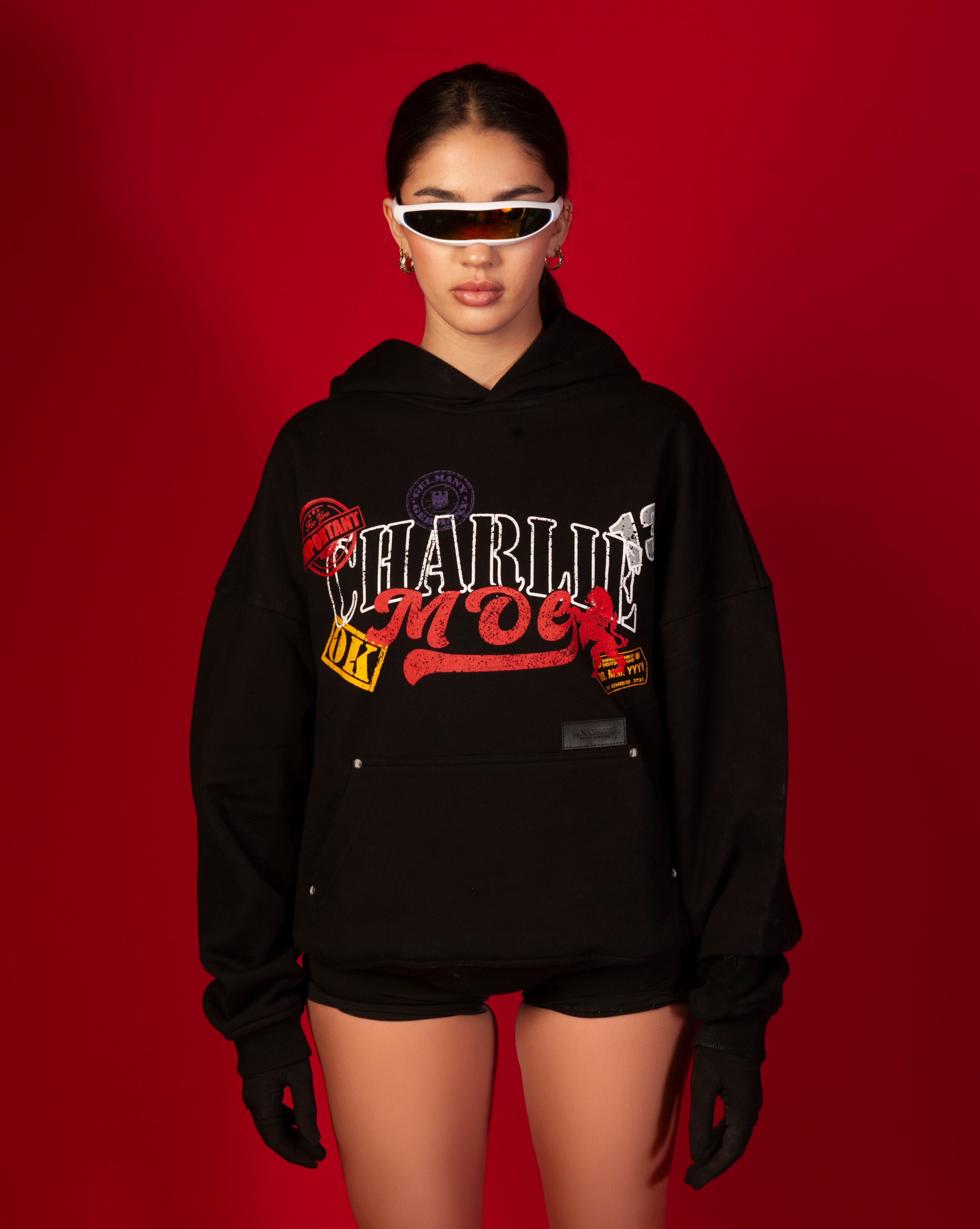 Stampel Hoodie MOE CHARLIE weiblich, Frontansicht, Stamp-Print sichtbar, weisser Visor, schwarze Shorts