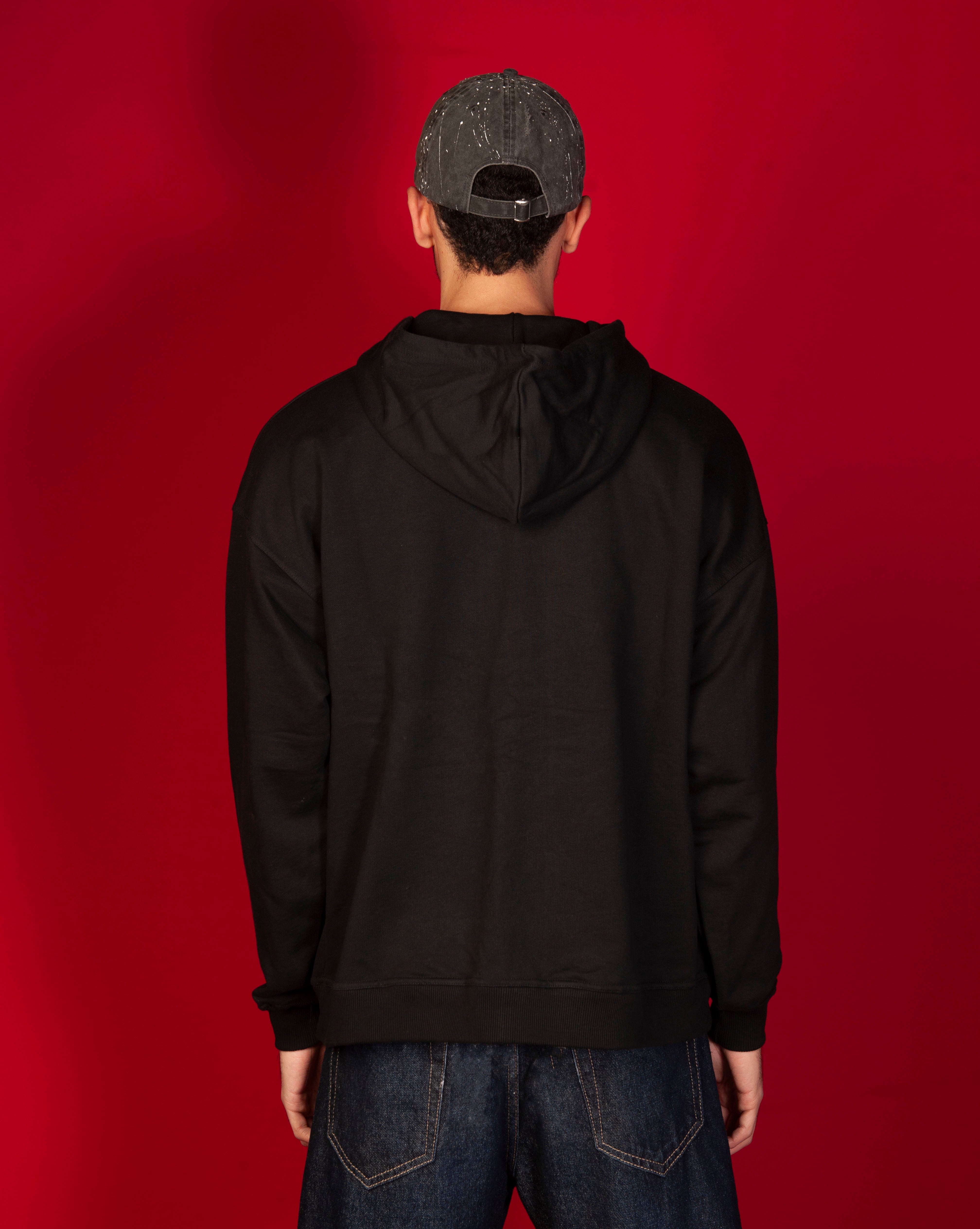 Rueckenansicht Basic 460 Hoodie MOE CHARLIE, saubere schwarze Rueckseite, Farbspritzer-Cap von hinten, dunkle Jeans